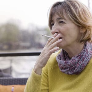Older woman smoking a cigarette