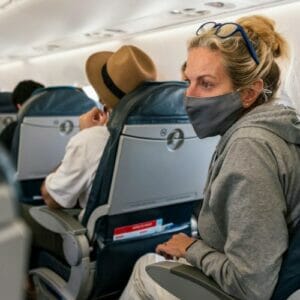 Woman wearing a mask on a plane