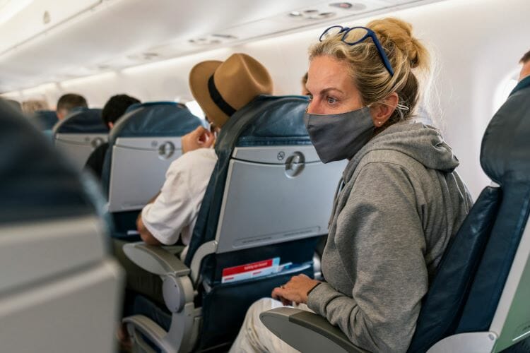 Woman wearing a mask on a plane