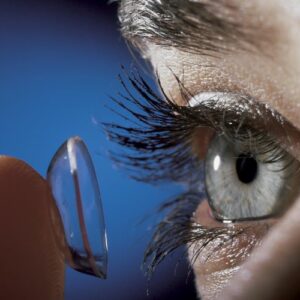 Stock image of woman putting on contact lenses